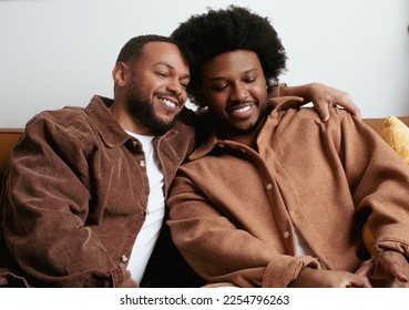 Queer Black males living in city doing everyday life things, like watering the plants and simply lounging. - Shutterstock ID 2254796263