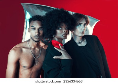 Queer, diversity and portrait of people in fashion with creative black woman, gay man and model on red background in studio. Lgbt, friends and beauty for edgy, aesthetic or unique makeup and clothes