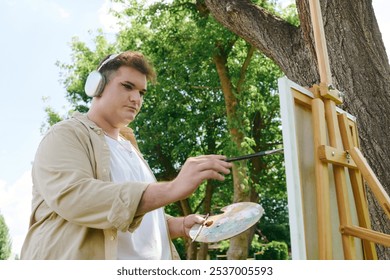 A queer person immersed in creative expression, painting on an easel surrounded by lush greenery. - Powered by Shutterstock