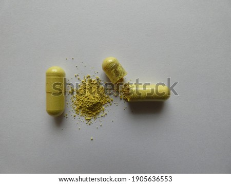 Quercetin capsule on white background.
