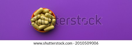 quercetin capsules on a lilac background. dietary supplement top view banner. mental wellbeing and personal health concept
