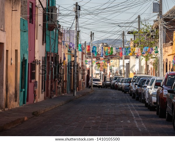 Queretaro, Mexico-April\
25 2019: A typical colorful backstreet scene early in the morning \
in the  historical city of Queretaro Mexico  which is a designated\
world heritage site.
