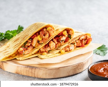 Quesadillas With Chicken Breast, Corn, Red Pepper, Tomatoes And Sauce On Wooden Cutting Board (plate). Toasted Sandwich, Traditional Mexican Snack, Corn Tortilla Wraps. Grey Background. Close Up Food.