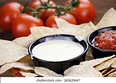 Queso Blanco Or White Cheese Sauce With Corn Tortilla Chips, Salsa And Fresh Tomatoes. Shallow Depth Of Field With Selective Focus On Cheese Dip.