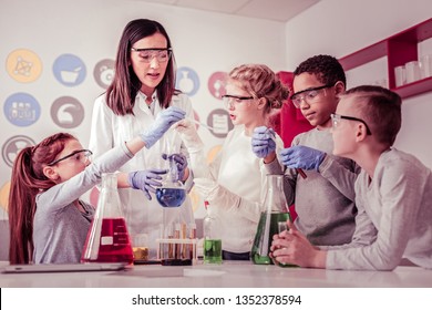 Question about chemistry. Young scientists helping their teacher with reagents and test tubes being involved in process - Powered by Shutterstock