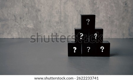 Question and answer concept. Stack of black cube with a symbol of question mark.
