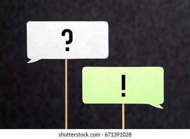 Question and answer. Interview, education and communication concept. Question and exclamation mark on cardboard speech bubble or balloon on wooden stick.