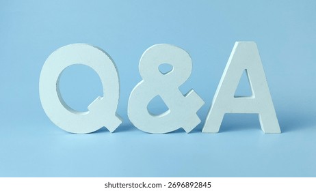 Question and Answer Session Concept: White QnA Letters on a Clean Blue Background