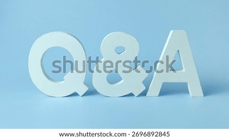 Question and Answer Session Concept: White QnA Letters on a Clean Blue Background