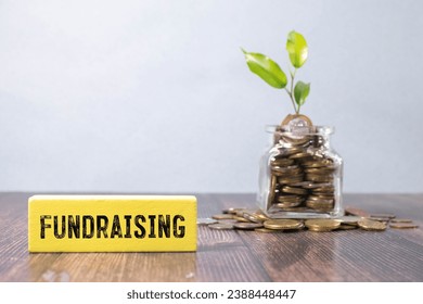 Question concept. On the table are cubes with questions and a red plaque with the inscription - Fundraising.