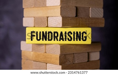 Question concept. On the table are cubes with questions and a red plaque with the inscription - Fundraising.