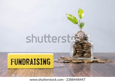 Question concept. On the table are cubes with questions and a red plaque with the inscription - Fundraising.