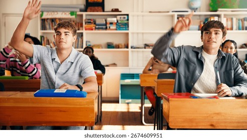 Question, lesson and students in class at high school with learning, education or participation in classroom. Teens, group and people with hands up for knowledge, academic development and interaction