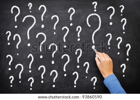 Question mark blackboard sign. Question marks on chalkboard. Decision, confusion, FAQ or other concept. Hand writing with chalk on school black board.
