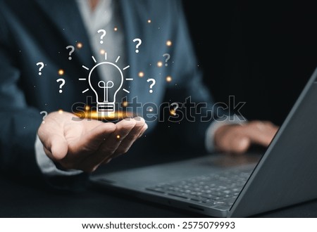 Question mark concept, Problems and solutions, Quiz, Survey, Support, Knowledge, Decision making. Businessman holding light bulb with question mark icon on virtual screen for FAQ.