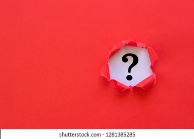 Question mark concept. Torn red paper with question mark on white background.