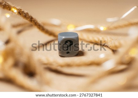 Question mark cube on warm decorative lights background. Concept of uncertainty, doubt, choice and decision making