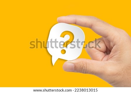Question mark design. Hand holding speech bubble with question mark on yellow background