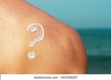 Question Mark Drawn By Sunscreen On A Male Back, Skin Protection Concept