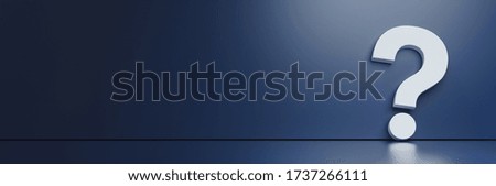 question mark in front of a dark blue color wall background. Business support concept 