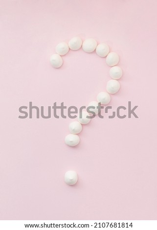 Question mark made of sweets on pastel background. Dilemma concept.
