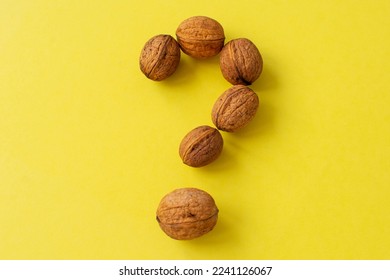 A question mark made of walnuts. The concept of frequently asked questions. - Powered by Shutterstock