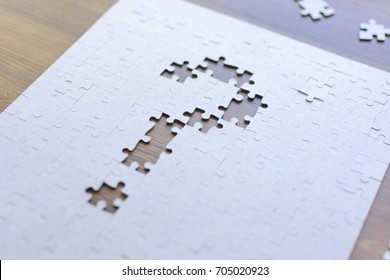 Question mark from the missing parts of the puzzle. Set goals, tasks and ways of their solution and implementation. Business concept. - Powered by Shutterstock - Get 15% off with code: PIKWIZARD15