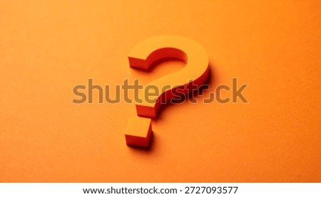 Question mark on orange background. FAQ and QA. Problem solution. Close-up.