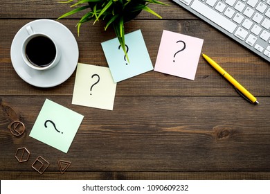 Question mark on sticky notes on office desk on dark wooden background top view copy space. FAQ concept. Working with clients. Troubles in work. - Shutterstock ID 1090609232