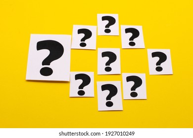 a question mark on a white sheet . FAQ frequency asked questions, Answer and Brainstorming Concepts