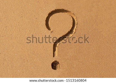 Question mark painted on sea sand