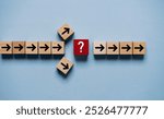Question mark print screen on red wooden block cross in the middle of arrow for interrupt of process concept.
