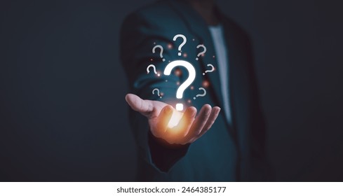 Question mark and problem analysis Concept, businessman's hand with question mark showing how to think analytically creatively or find out reasons that occur during work process of business.