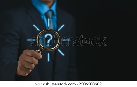 question mark and problem analysis Concept,businessman hand hold magnifying glass with question mark show how to creatively analyze and find reasons that occur during the work process of business.