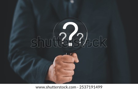 Question mark, Problem solving and analysis concept. Businessman holds magnifying glass focused on question mark, analysis, problem solving, identifying cause of issues during work process, solution,