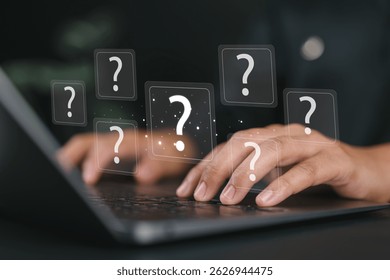 Question Mark and Problem Solving Concept. Man using a laptop with floating question marks, symbolizing brainstorming, problem-solving, and finding answers to business FAQs. creativity and ideas