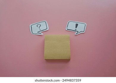 question mark in speech bubble on pink background. A piece of paper with a question mark, pinned to a pink surface, evoking curiosity. blank sticky notes.