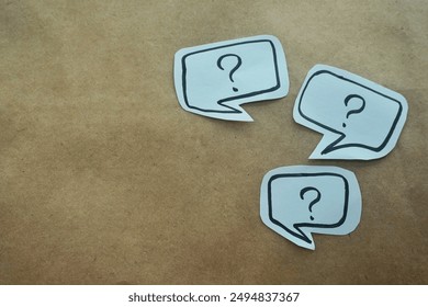 question mark in speech bubble on pink background. A piece of paper with a question mark, pinned to a pink surface, evoking curiosity. blank sticky notes.