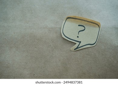 question mark in speech bubble on pink background. A piece of paper with a question mark, pinned to a pink surface, evoking curiosity. blank sticky notes.
