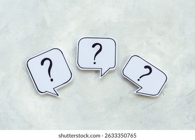 Question marks on speech bubbles, top view. Ask and answer concept