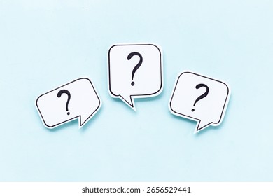 Question marks on speech bubbles, top view. Ask and answer concept