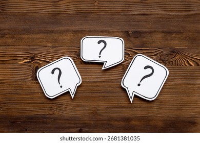 Question marks on speech bubbles, top view. Ask and answer concept