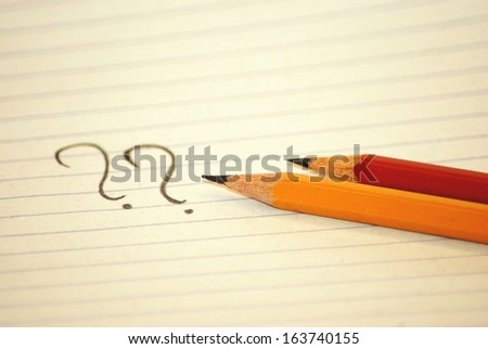 Question marks and pencils
