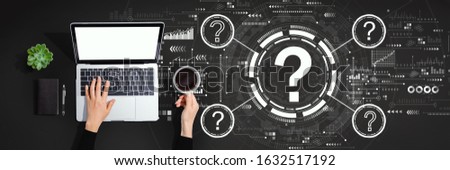 Question marks with person using a laptop computer