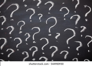 Question marks written on blackboard. Problems to solve concept.