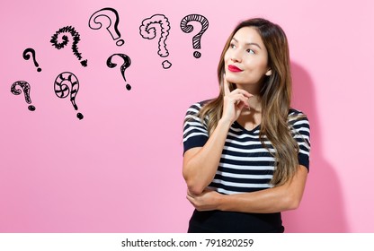 Question Marks with young woman in a thoughtful pose