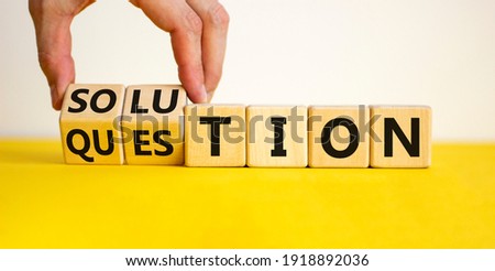 Question and solution symbol. Businessman turns wooden cubes and changes the word 'question' to 'solution'. Beautiful yellow table, white background, copy space. Business question and solution concept
