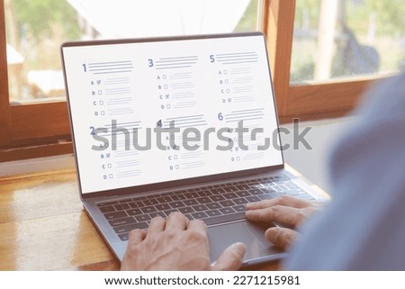 Questionnaire online with checkboxes. A man passing online exam. Evaluation, survey online exam Choosing the right answer in the exam, Test questions. Filling out online survey form business.