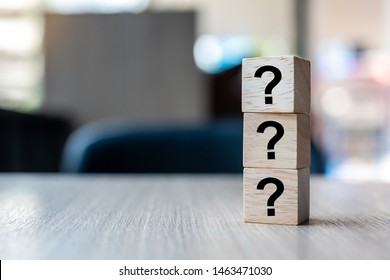 Questions Mark ( ? ) word with wooden cube block on table background. FAQ( frequency asked questions), Answer, Q&A, Information, Communication and Brainstorming Concepts