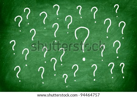 Questions. Question mark on green chalkboard / blackboard.